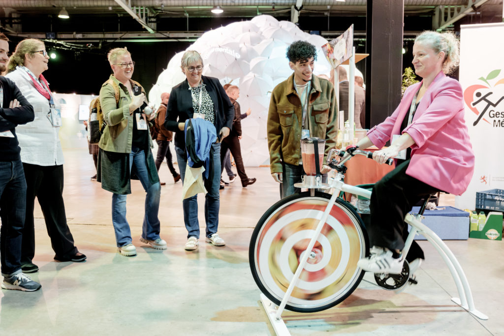 Groupe de visiteurs devant une démonstration de vélo - Forum SST 2024